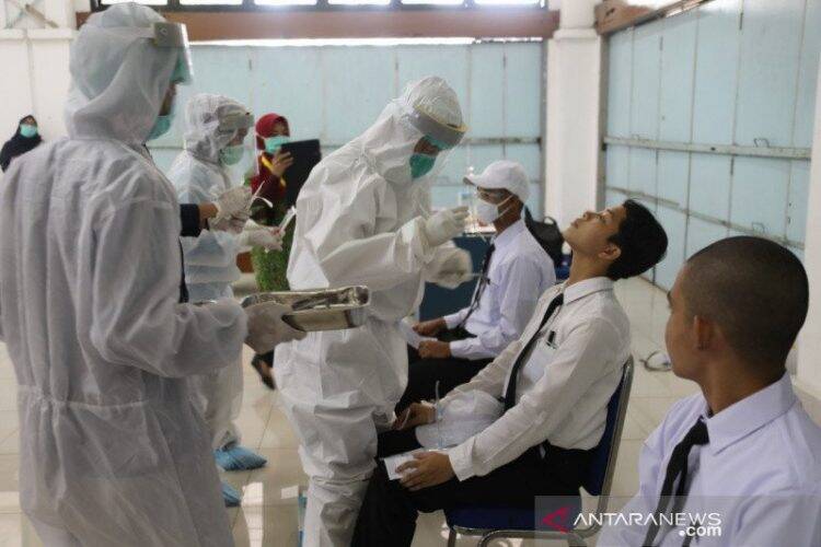 Petugas medis melakukan tes usap terhadap para calon muda praja IPDN di Kampus IPDN Jatinangor